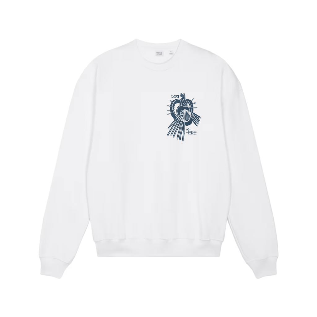 A white crewneck sweatshirt shown from the front, featuring an indigo blue graphic print of a little human heart enclosed in the womb of the Sacred Divine Mercy Heart of Jesus enclosed in the womb of Immaculate Sorrowful Heart of Mary wit the words LOVE and BE HERE